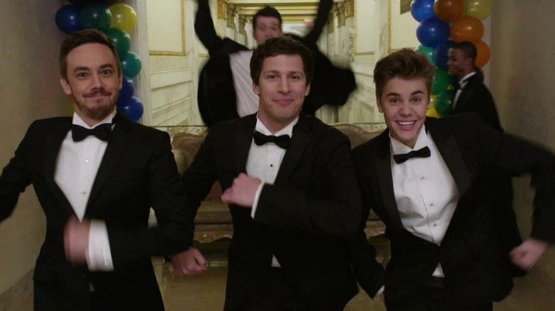 Taccone, Samberg, and Bieber dancing wearing tuxedos