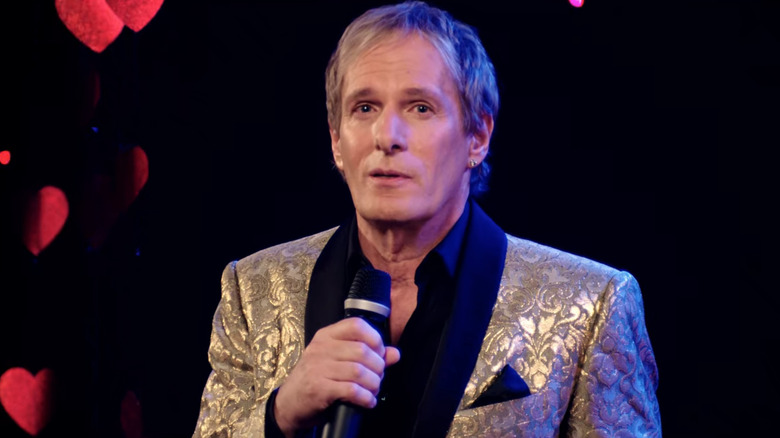 Michael Bolton holding microphone and singing