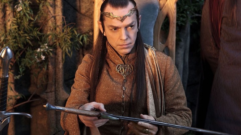 Elrond looks at a sword