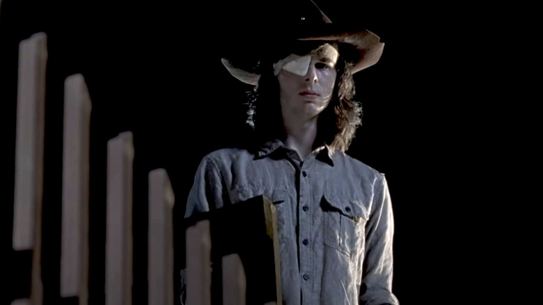 Carl Grimes standing by fence