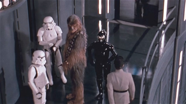 Chewie being escorted by Stormtroopers 