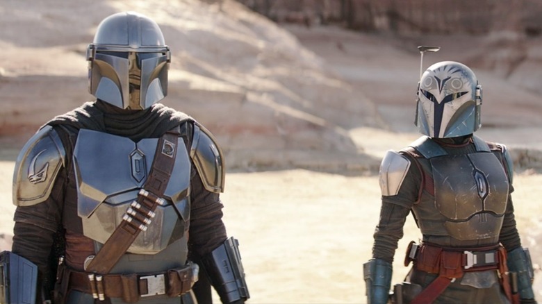 The Mandalorian and Bo-Katan standing together