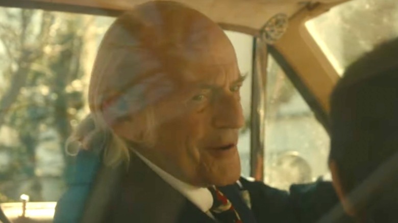 Grandpa Maguire smiling in a car in The Tender Bar