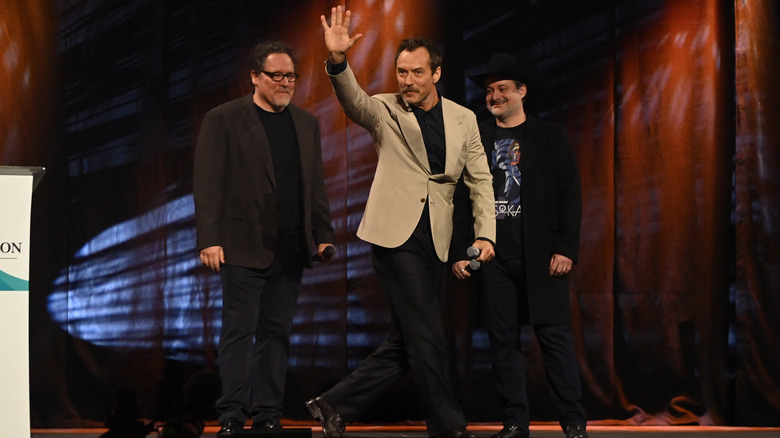 Jon Favreau, Jude Law, and Dave Filoni on stage