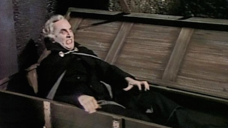 Norman Welsh rises from a coffin