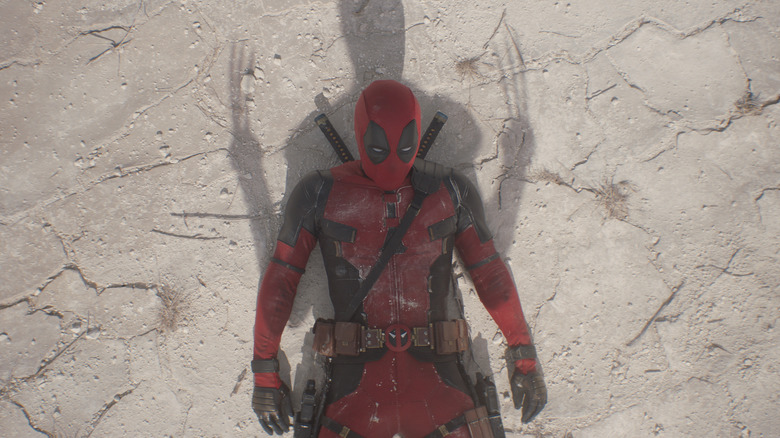 Wolverine standing over Deadpool