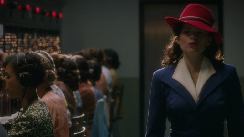 Peggy Carter walks past a switchboard 