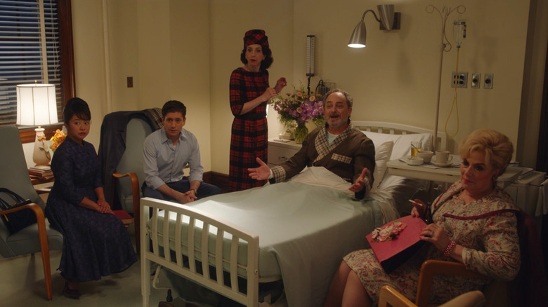 Mei, Joel, Rose, and Shirley gathering around Moishe's bed at the hospital