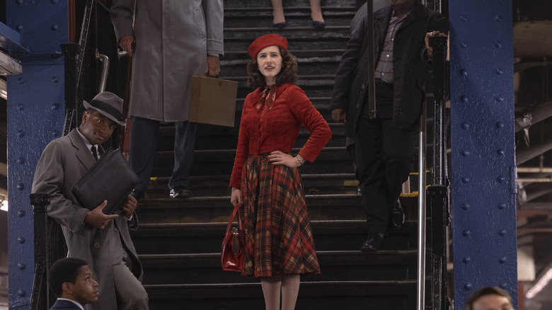 Mrs. Maisel standing on a staircase