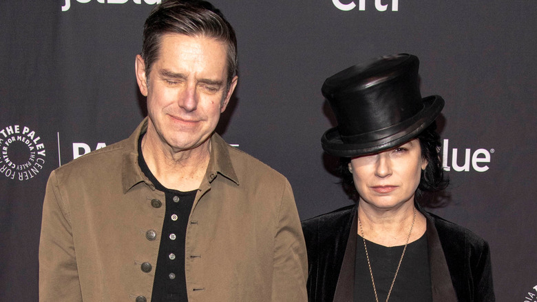 Daniel Palladino wincing and Amy Sherman-Palladino hat