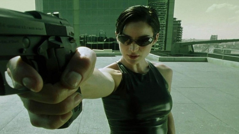 Carrie-Anne Moss Trinity pointing gun