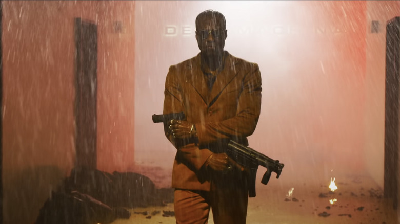  Yahya Abdul-Mateen II as Morpehus weilding guns in the rain