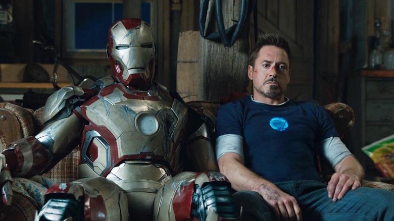 Tony Stark sits with the Iron Man armor