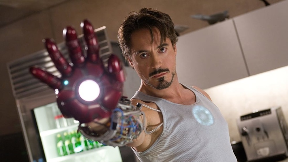 Robert Downey Jr. aiming Iron Man glove