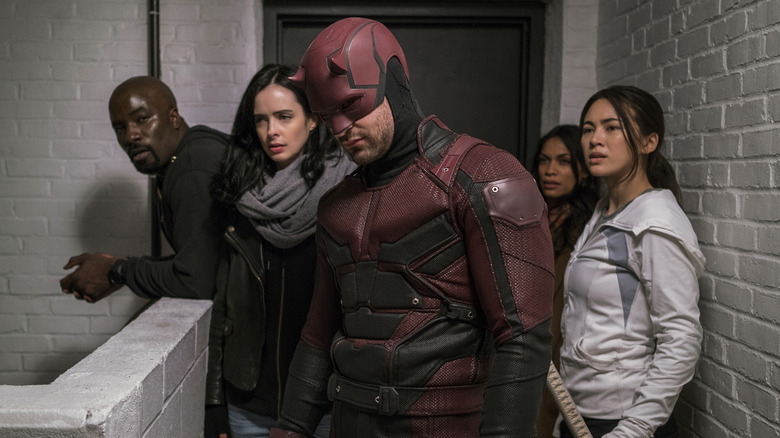 Daredevil, Jessica Jones, Luke Cage, Colleen Wing, and Claire Temple in a hallway