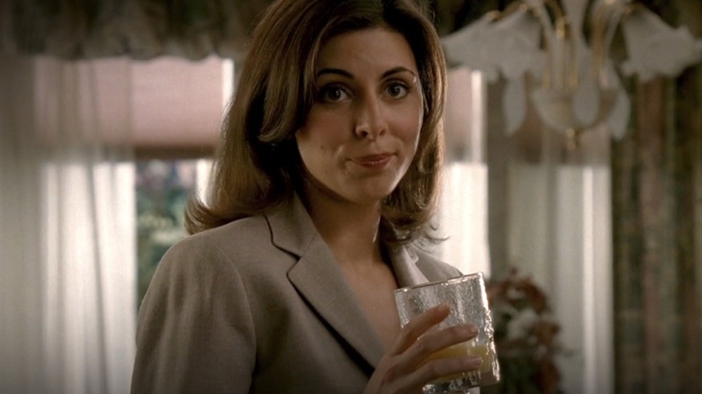 Meadow Soprano holding glass of juice