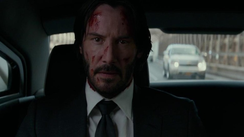 A bloodied John Wick travels