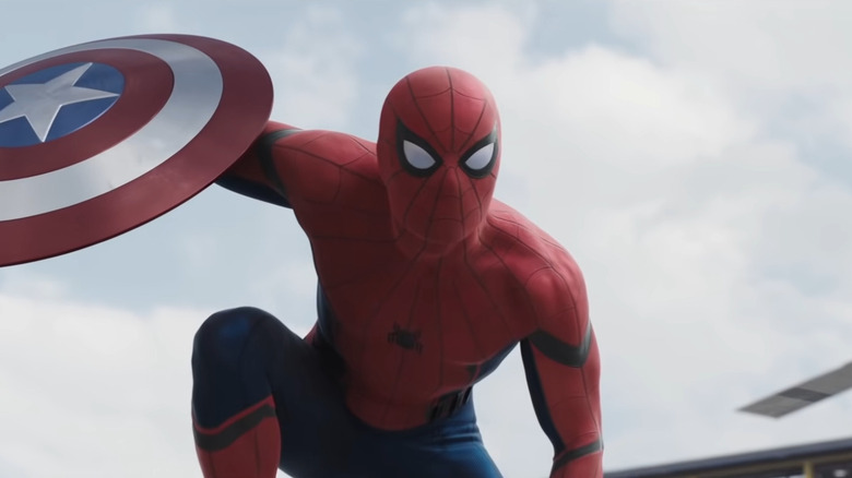 Spider-Man holding Captain America's shield