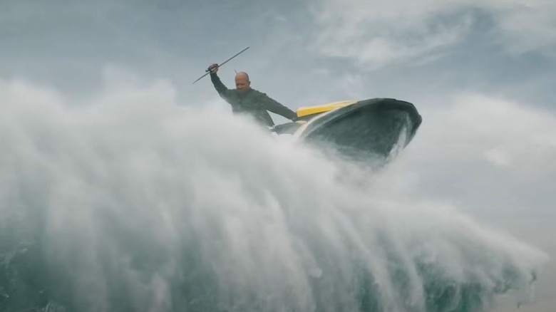 Jonas Taylor driving Jet Ski over a wave