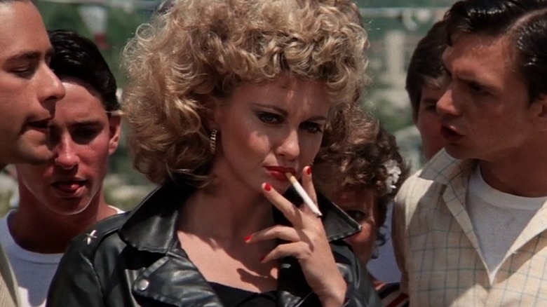 Olivia Newton-John as Sandy smoking