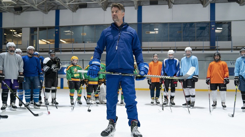 Coach Colin Cole on the ice with hockey players