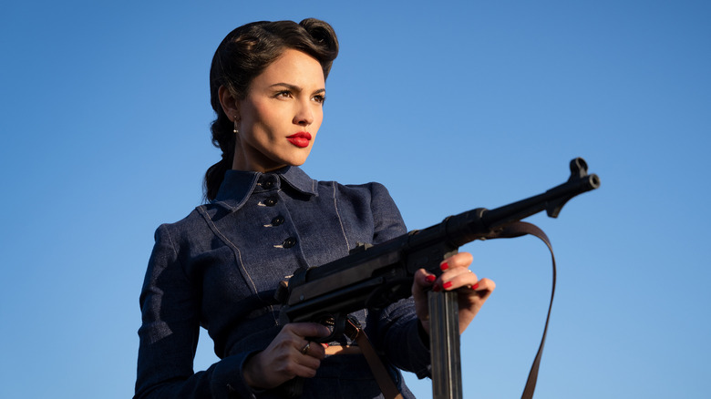 Marjorie holding submachine gun