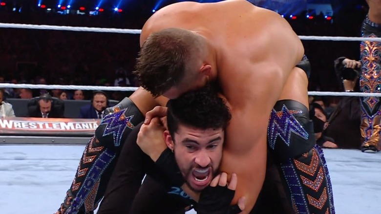 Miz puts Bad Bunny in a headlock