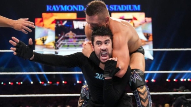 Miz puts Bad Bunny in a headlock