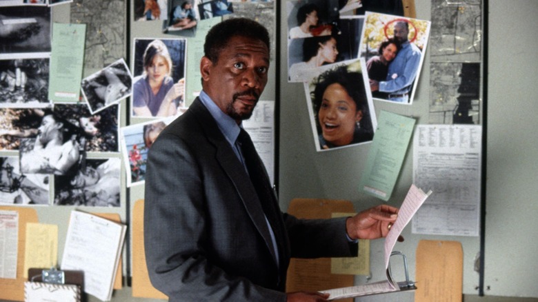 Alex Cross holding file