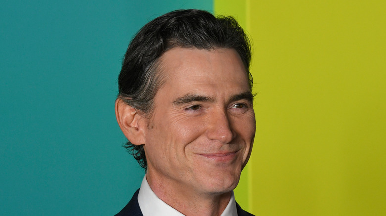 Billy Crudup blue green background