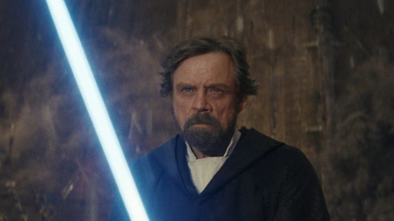 Luke Skywalker holding lightsaber 