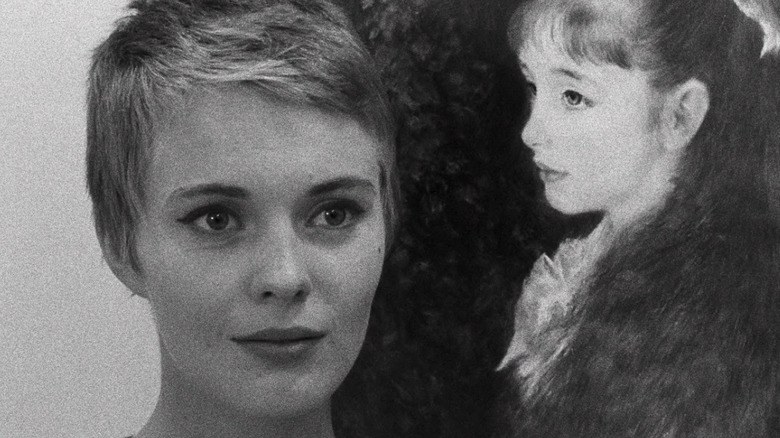 Jean Seberg wide eyed next to poster of girl