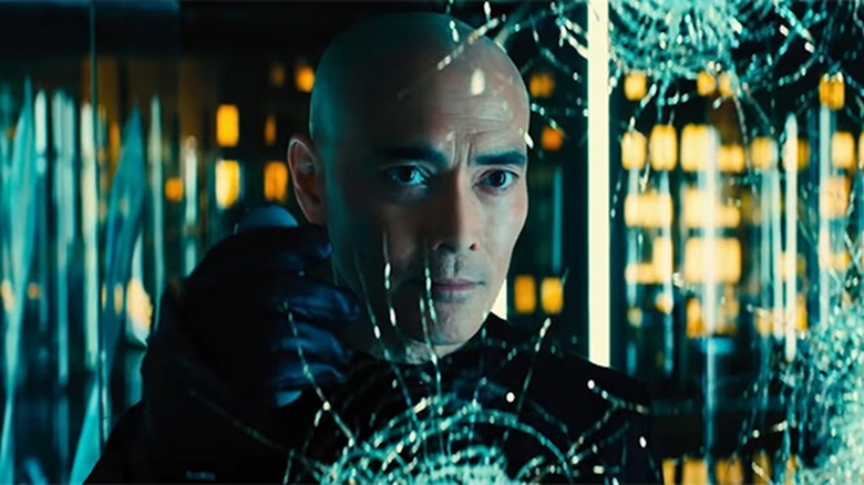 Zero from John Wick looking through a broken window