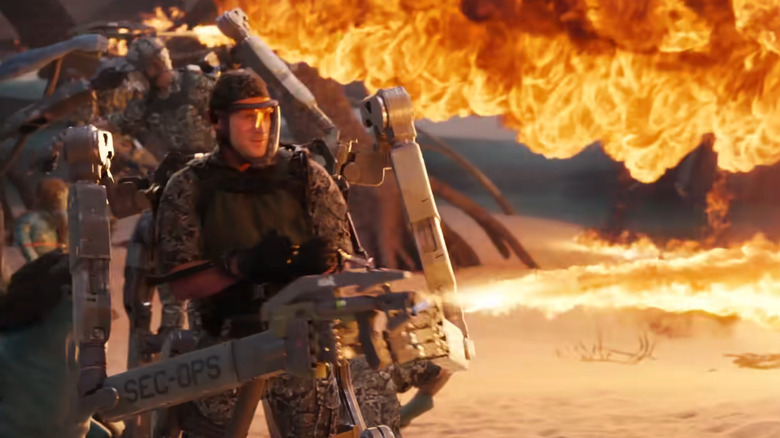 Human in mech suit using flamethrower