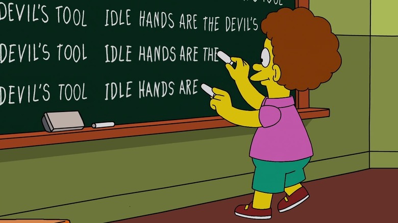 Todd Flanders writing on a blackboard 