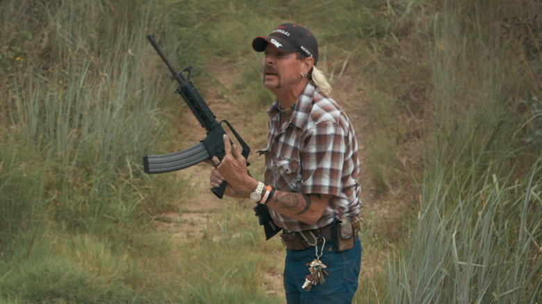 Joe Exotic holds assault rifle