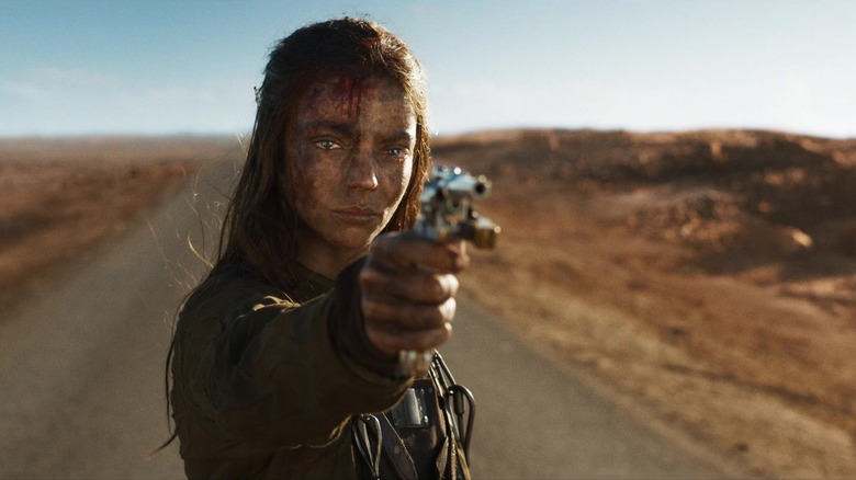 Furiosa pointing a gun