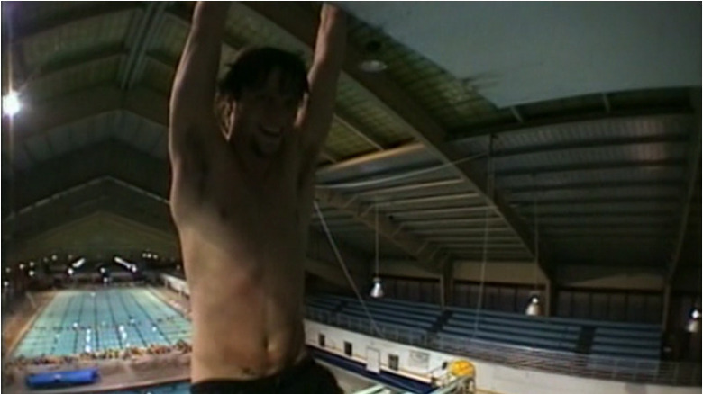 Bam Margera hanging from diving board