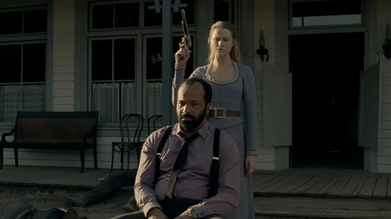 Dolores holding gun behind Bernard 