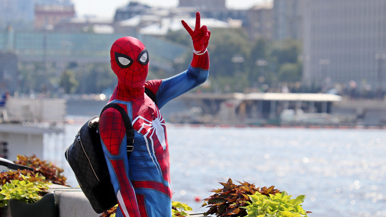 Spider-Man cosplayer flashes peace sign