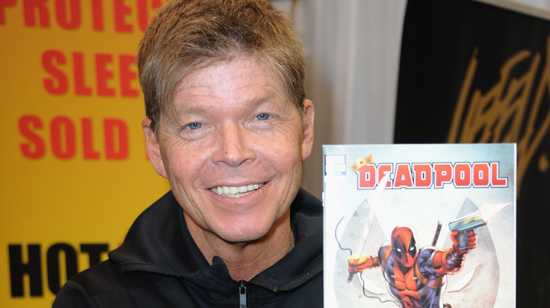 Rob Liefeld holds Deadpool comic