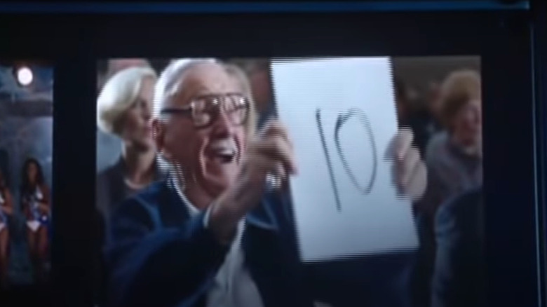 Stan Lee holding up 10 sign