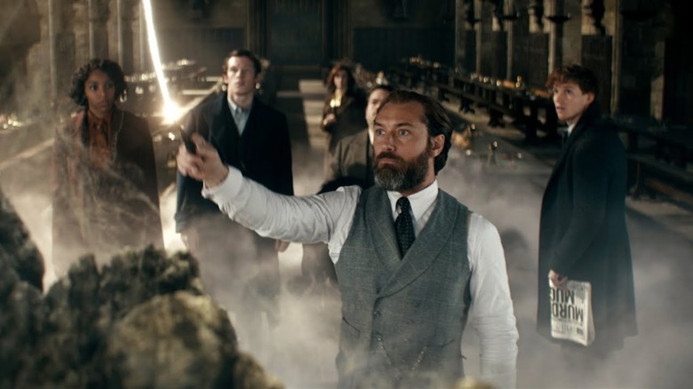 Dumbledore waving his wand while others watch