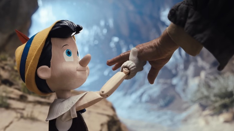 Pinocchio holding Geppetto's hand