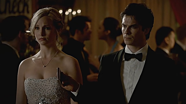 Damon offering Caroline a flask