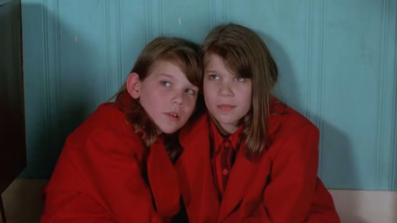 Twin girls wearing red