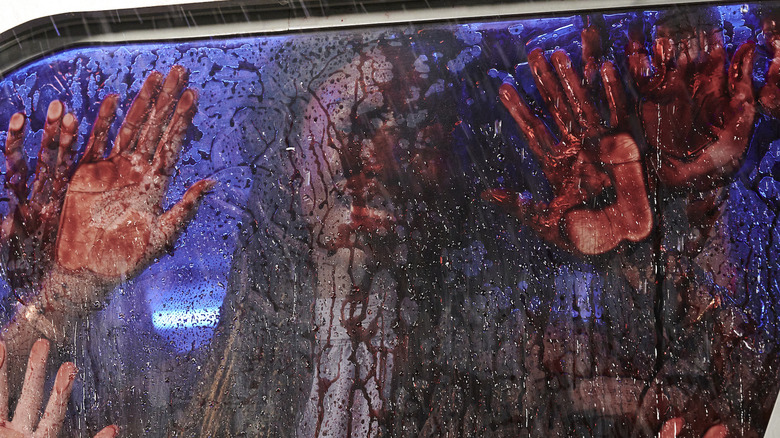 bloody hands on a window