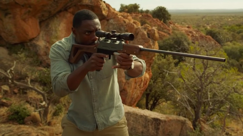 Idris Elba takes aim with his rifle