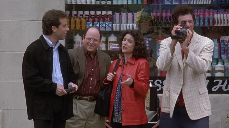 Jerry, George, Elaine and Kramer laughing at someone