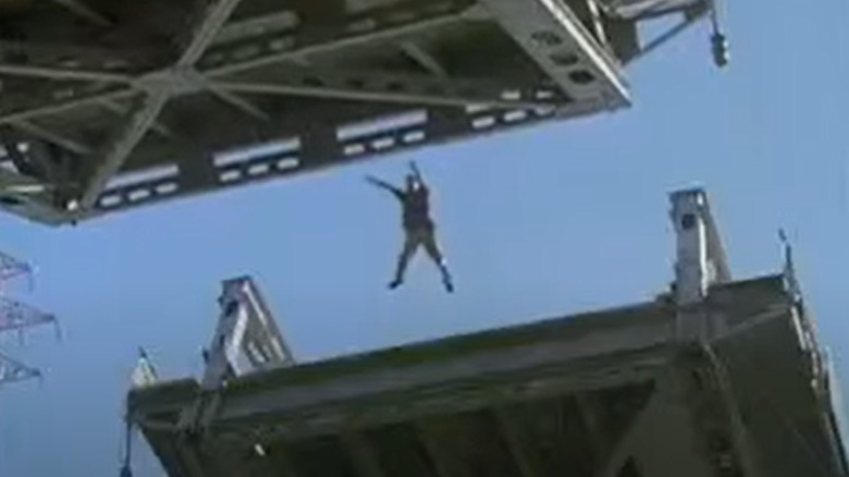 Man jumping between drawbridge in "The Fugitive"